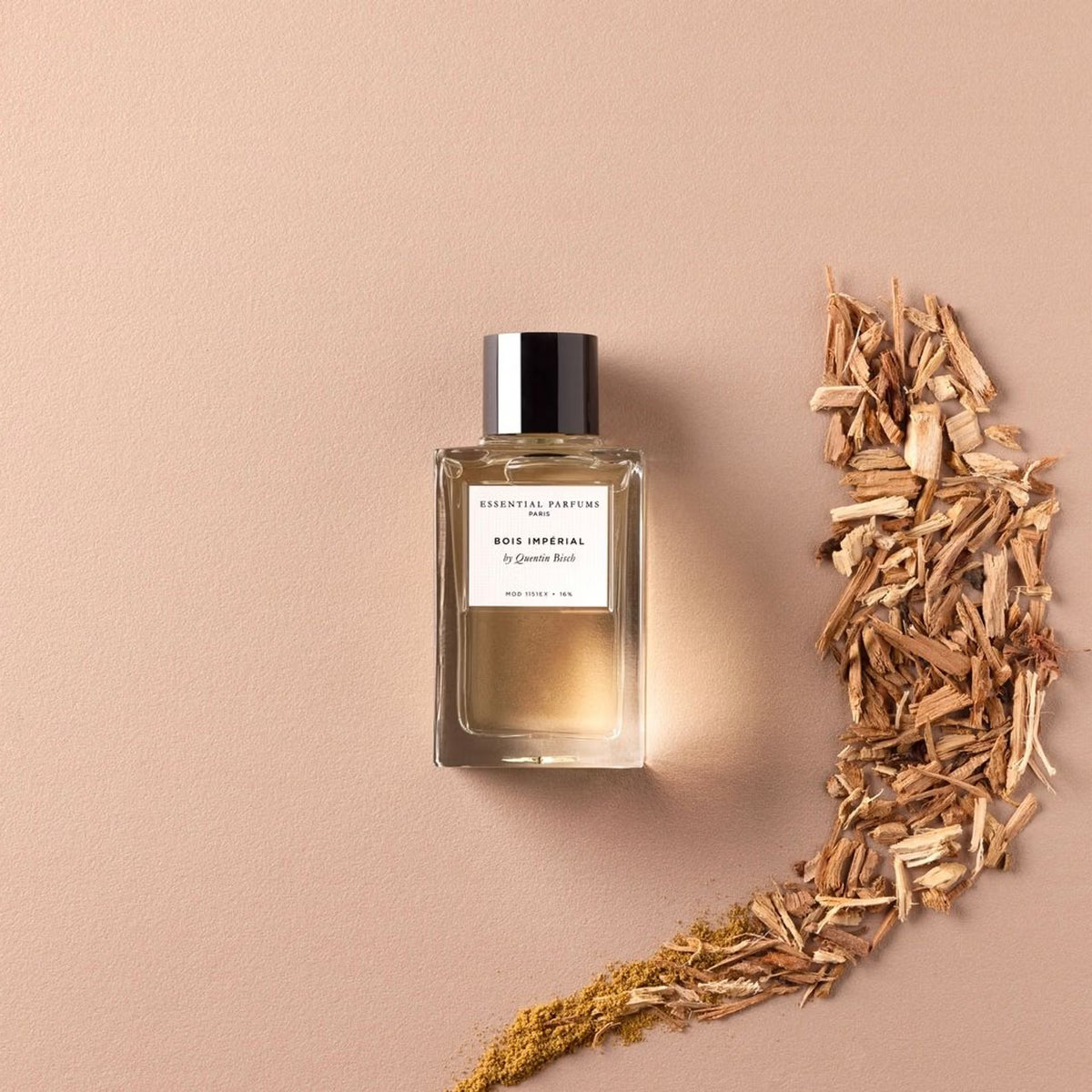 Essential Parfums Bois Imperial bottle staged among wood elements