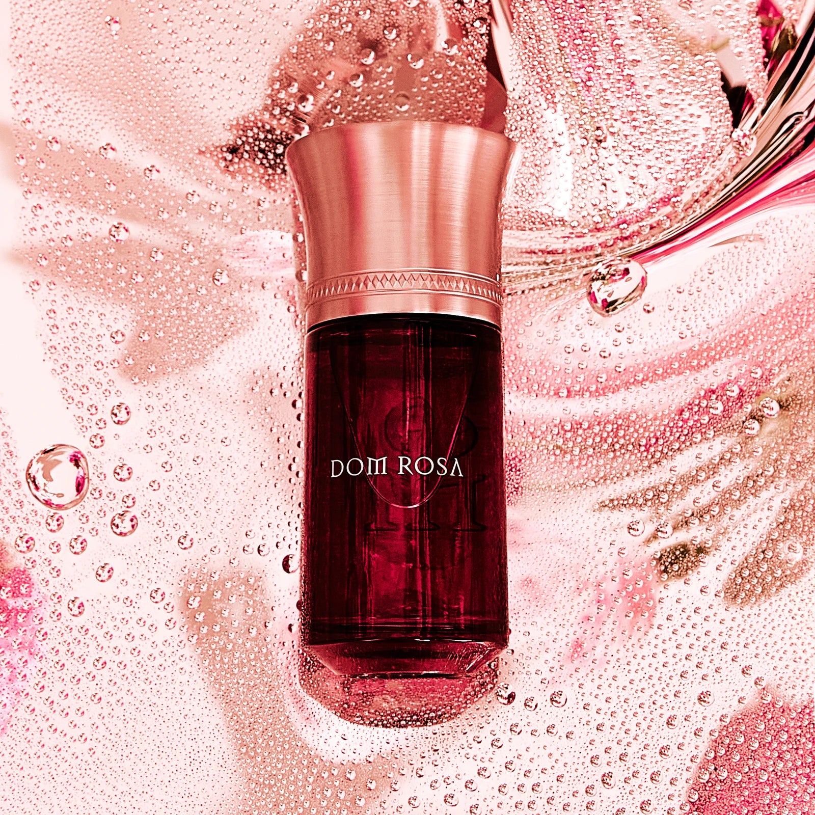 Liquides Imaginaires Dom Rosa Flakon auf rosa Wasser mit Perlen und Tropfen